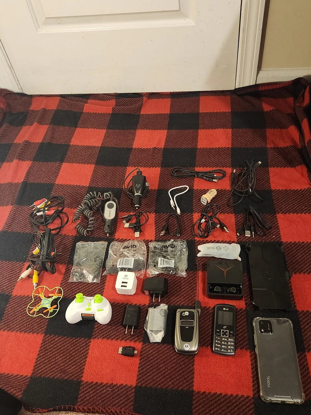 Elctronics Lot, Cellphones, Charging Cords, Remotes, And More